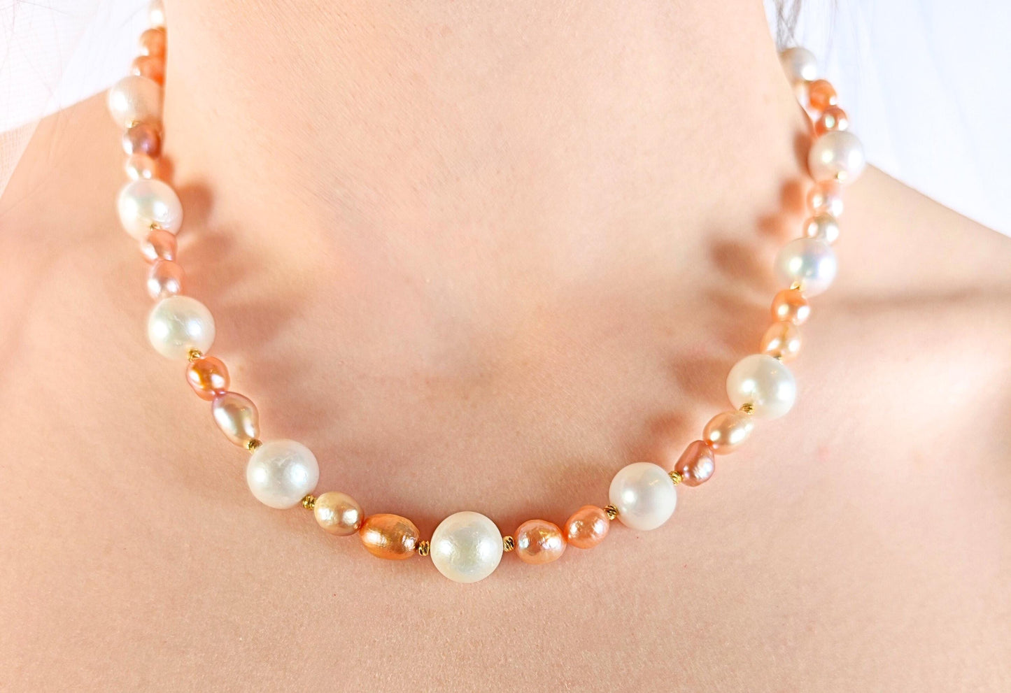 Pearl necklace with orange accents on a mannequin