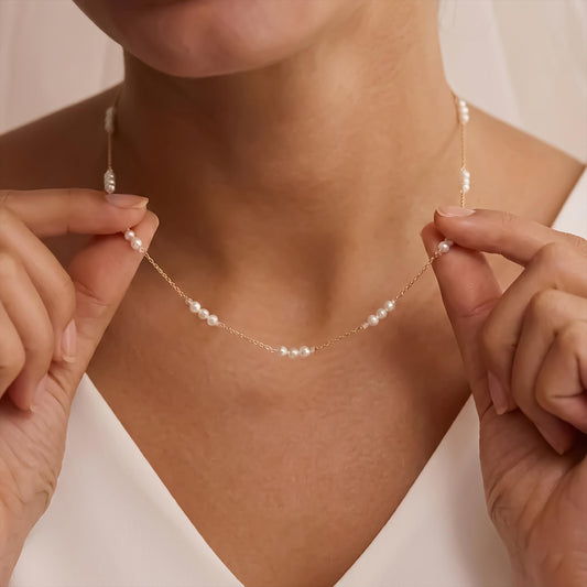 Person holding a delicate pearl necklace