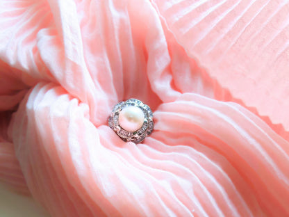 Close-up of a pink fabric flower with a pearl center