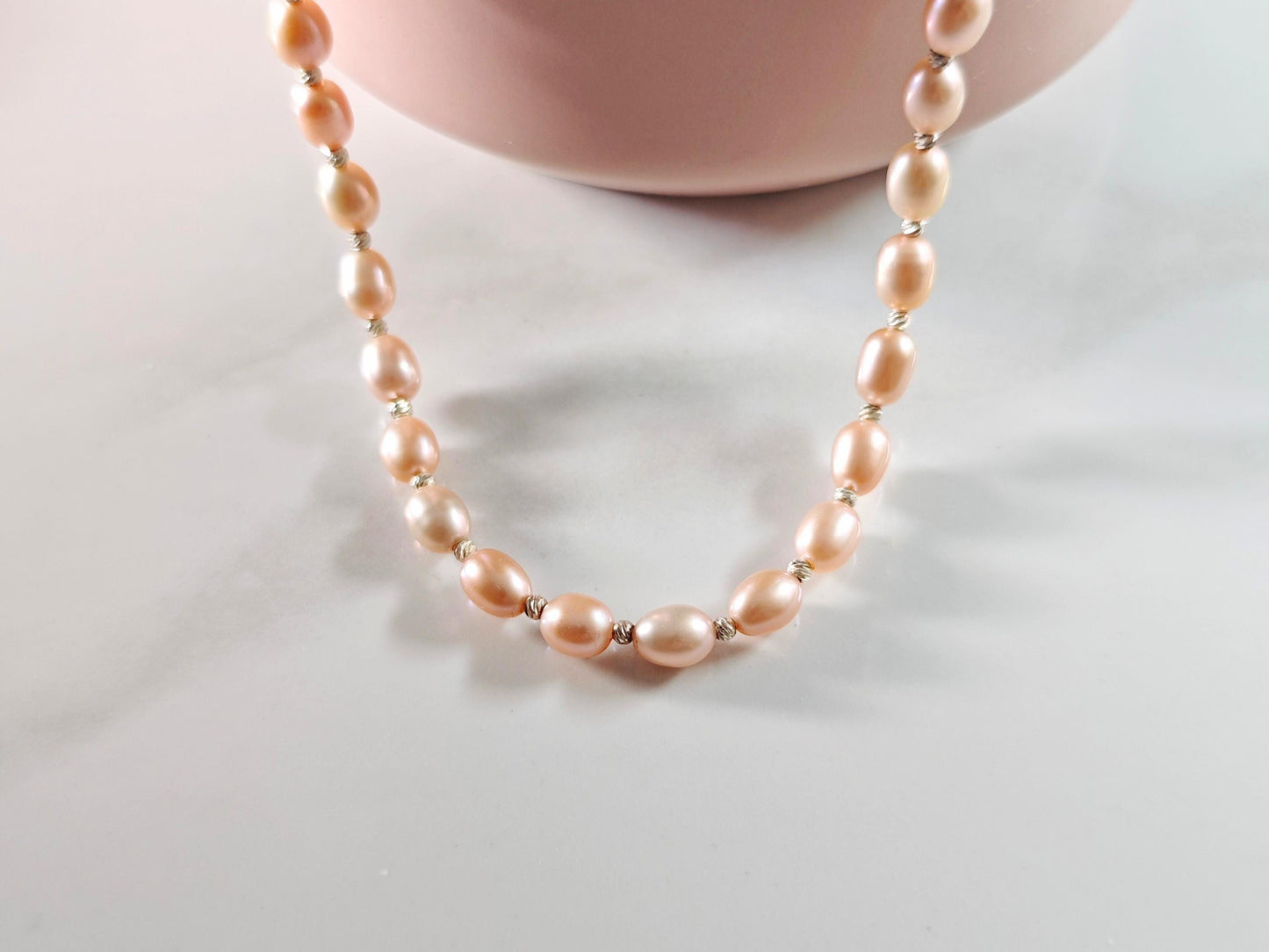 Pearl necklace on a light gray background