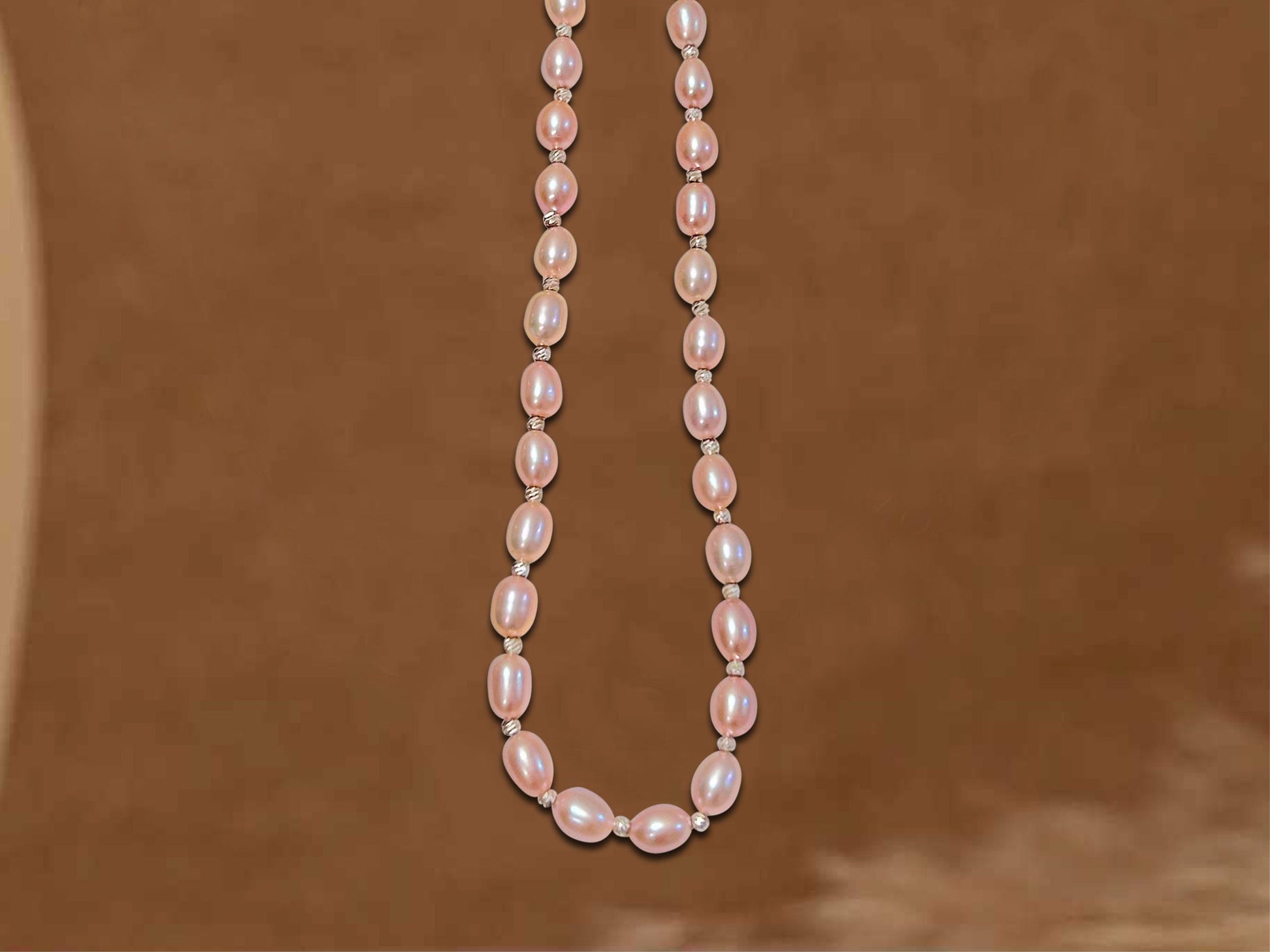 Pearl necklace on a brown background