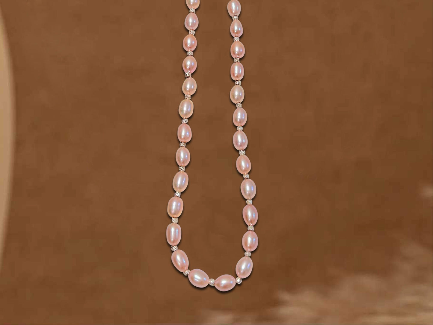 Pearl necklace on a brown background