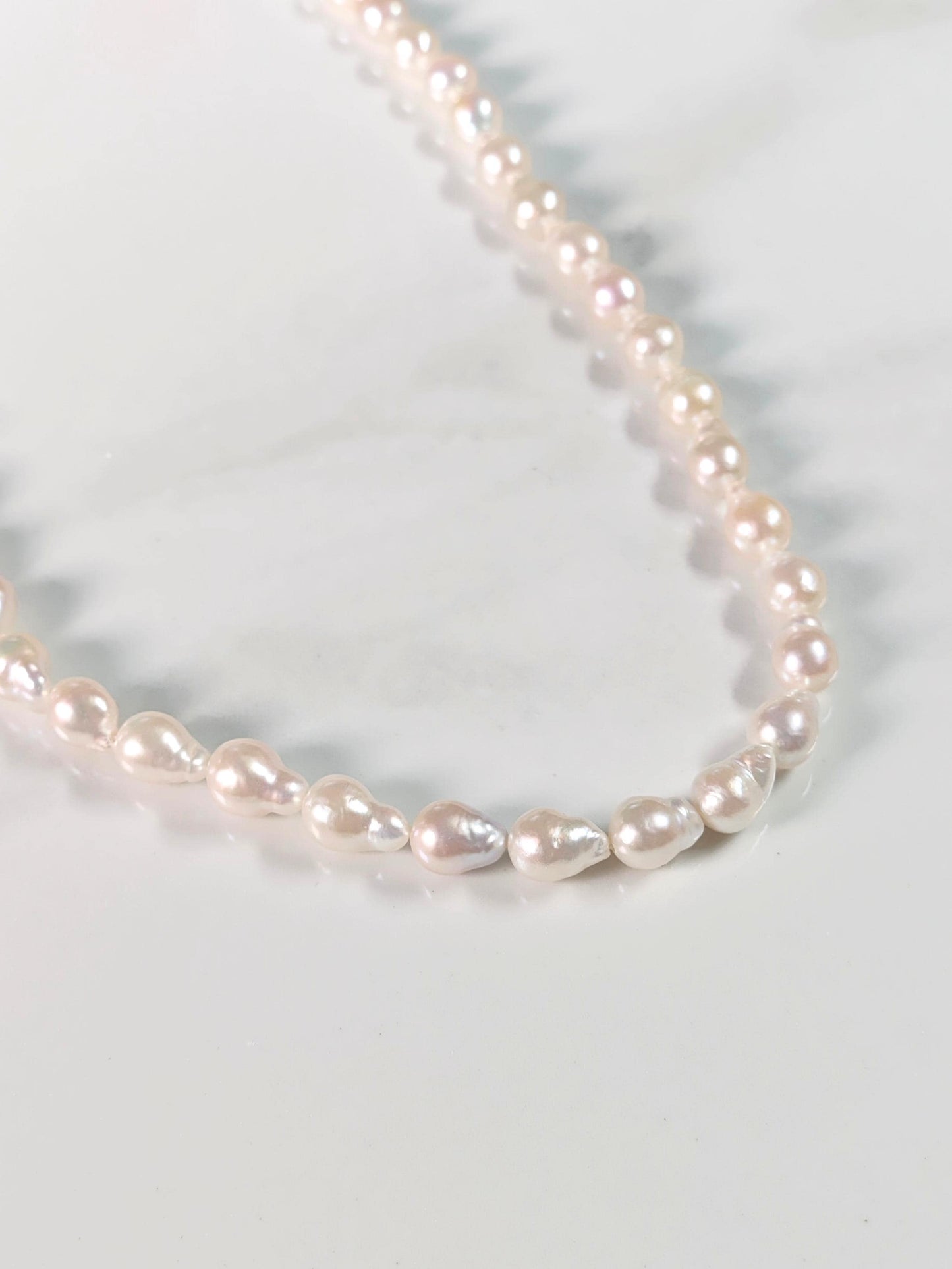 Pearl necklace on a marble surface