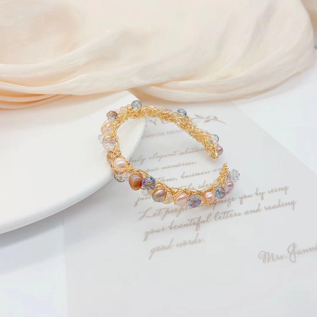 Delicate bracelet with beads on a soft fabric background