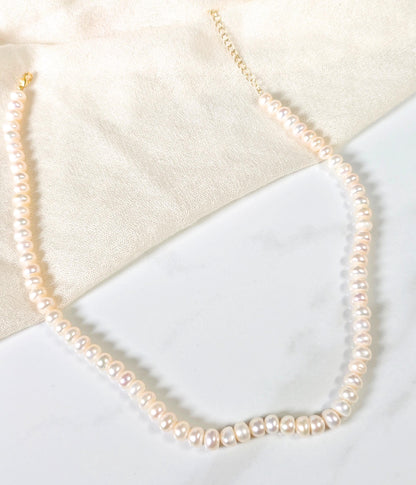 Pearl necklace on a light background