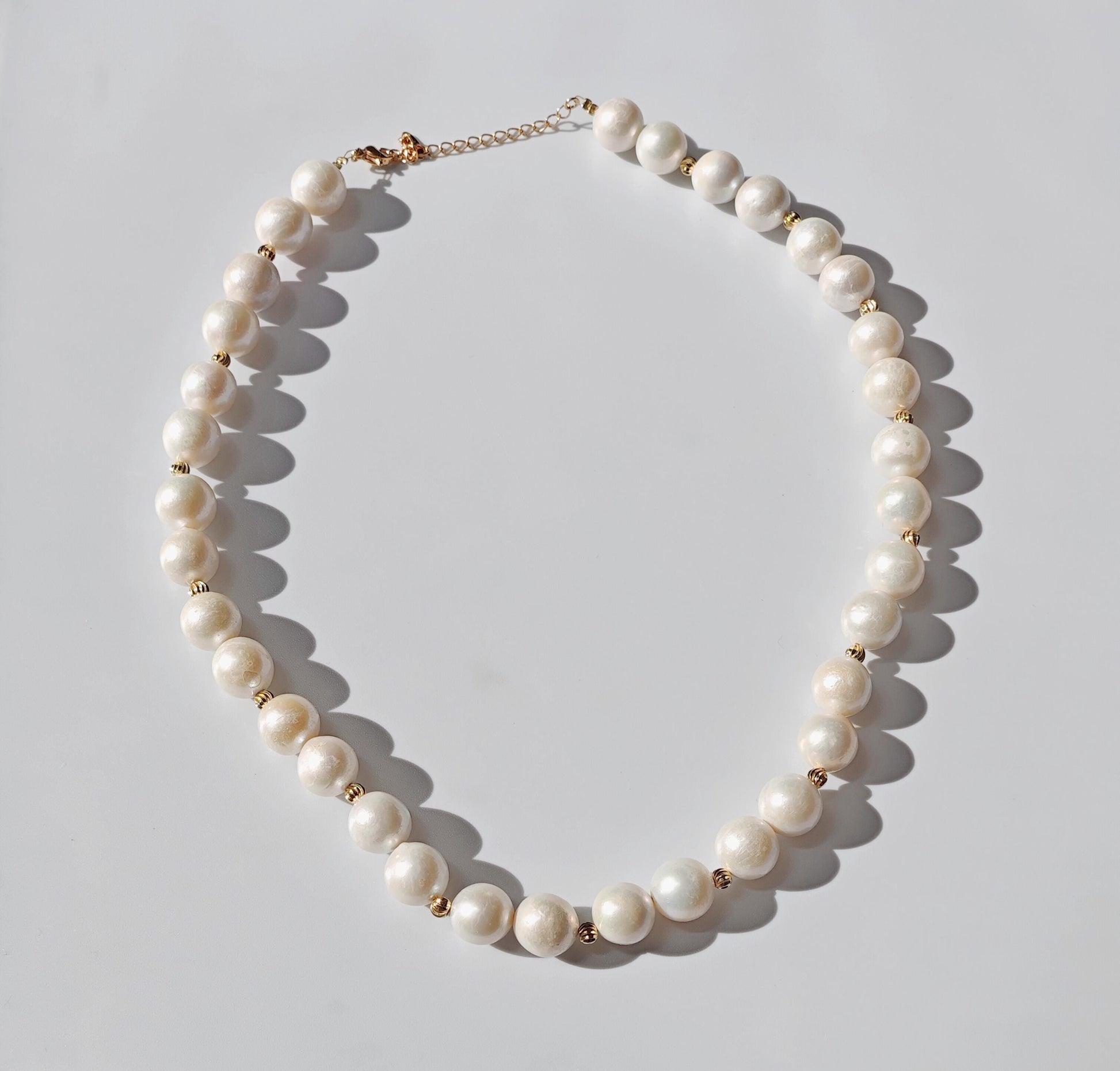 Pearl necklace on a light gray background