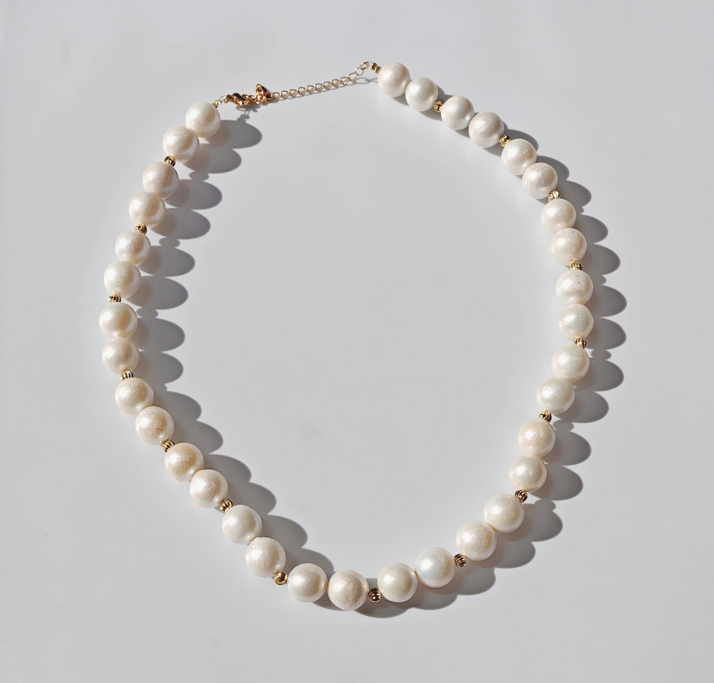 Pearl necklace on a light gray background