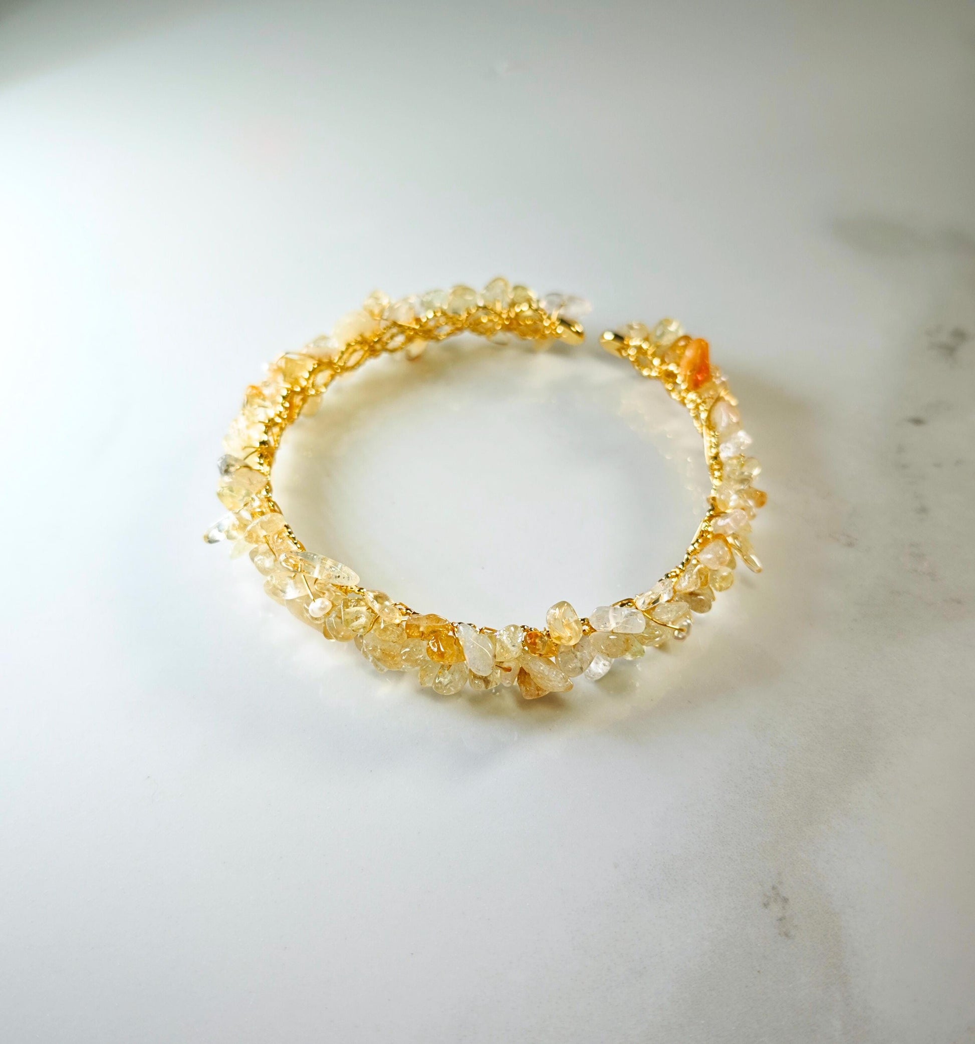 Bracelet with natural stone beads on a light marble surface