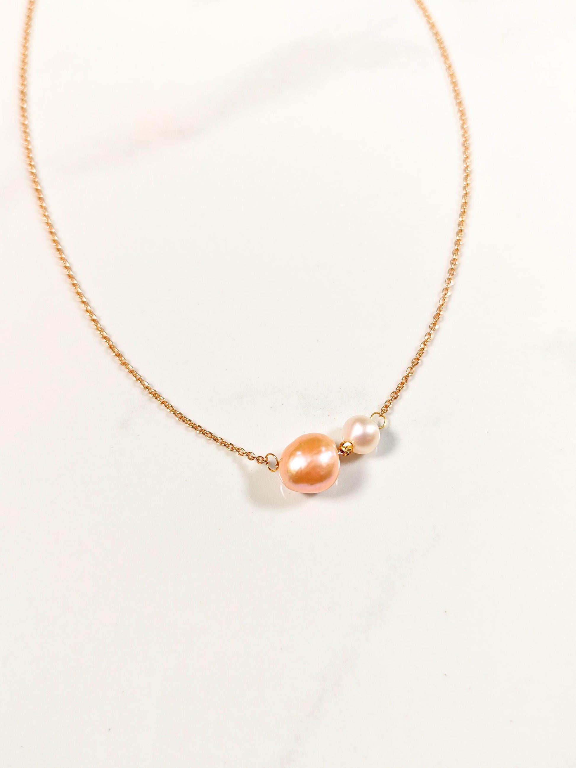Necklace with pink and white pearls on a light background