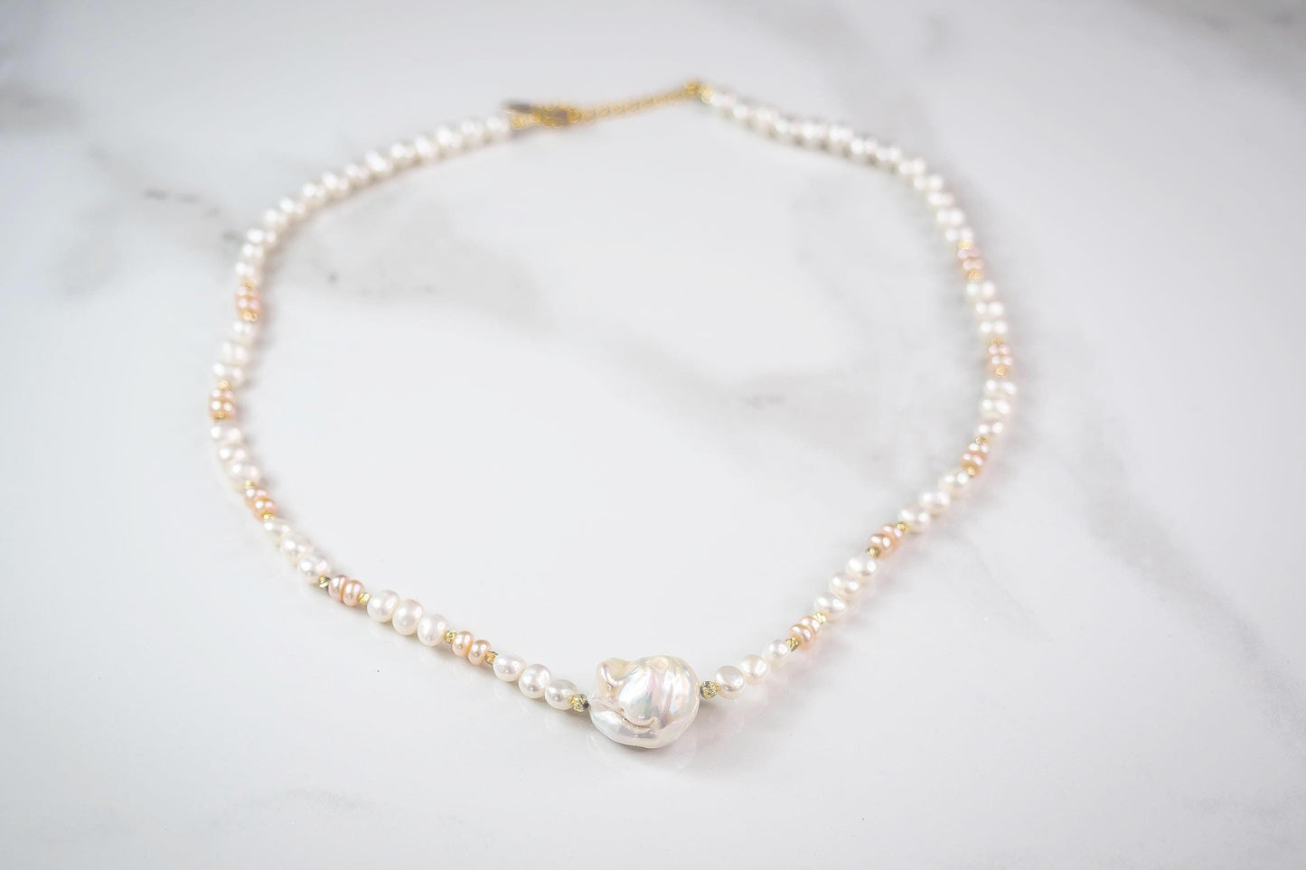 Pearl necklace on a light gray background