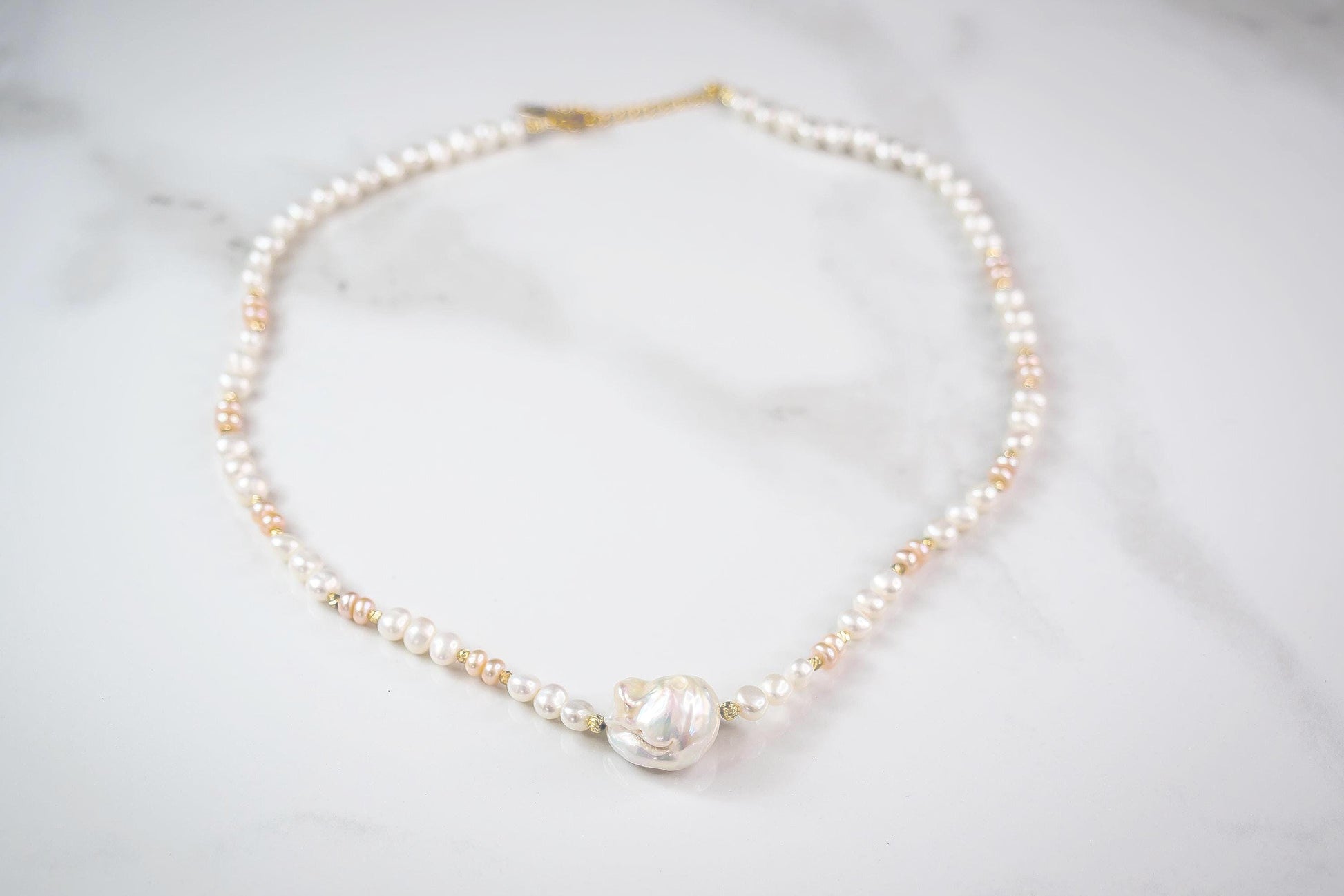 Pearl necklace on a light gray background