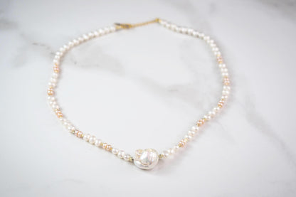 Pearl necklace on a light gray background