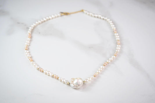 Pearl necklace on a light gray background