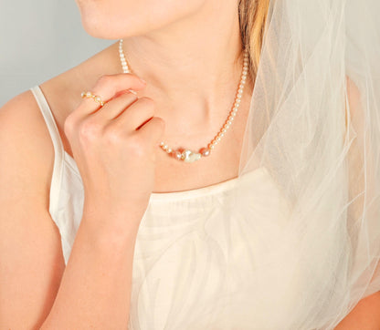 Woman wearing a pearl necklace with a soft focus background