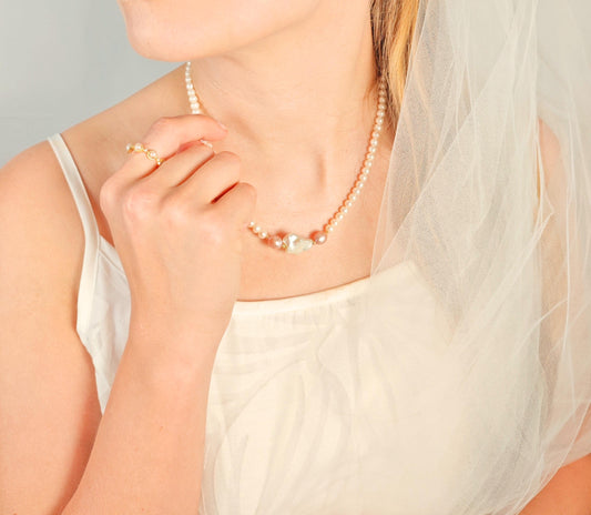 Woman wearing a pearl necklace with a soft focus background