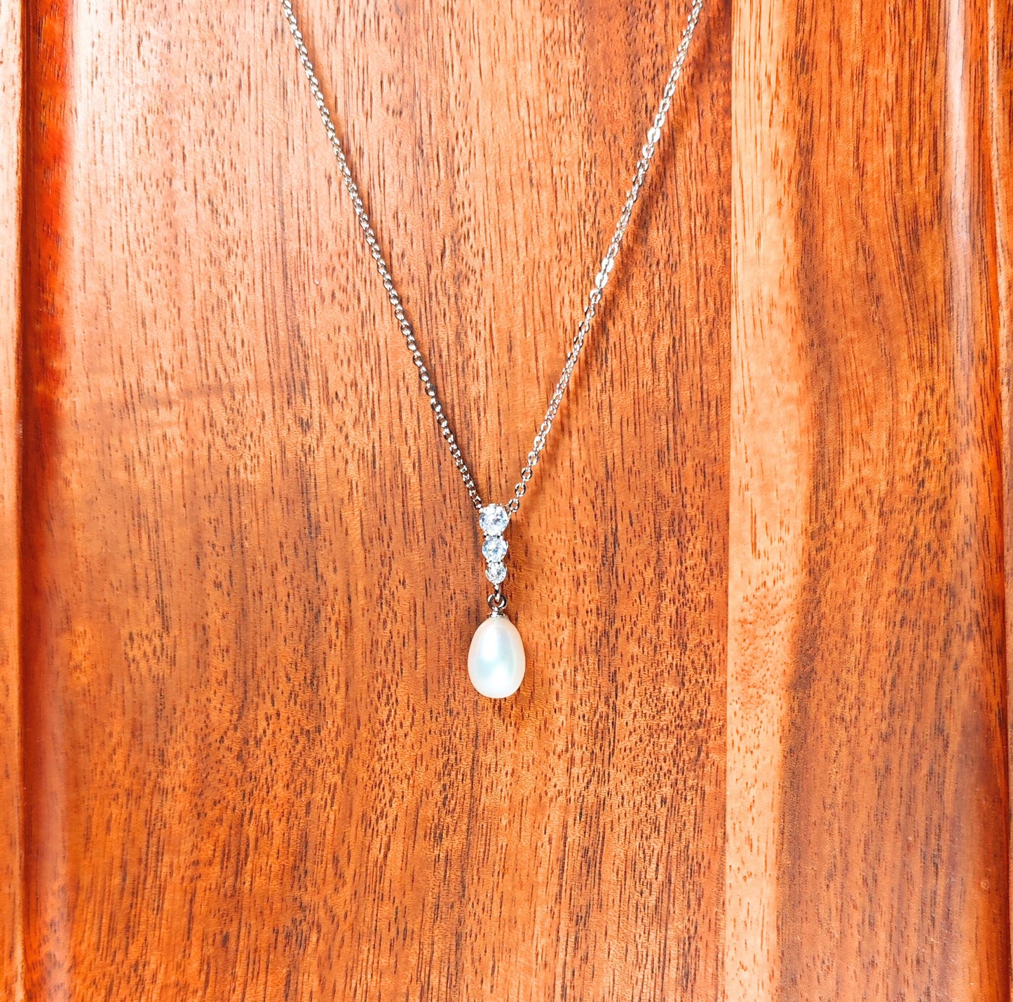 Necklace with a pendant on a wooden surface