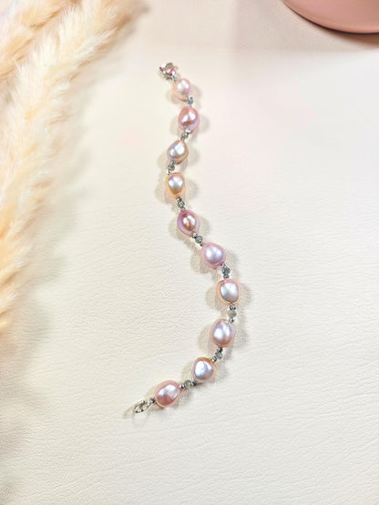Pearl bracelet on a person wearing a light-colored sweater