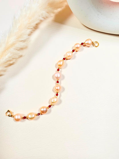 Pearl bracelet with gold accents on a soft beige background