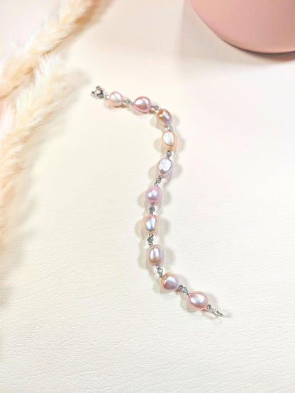 Pearl bracelet on a white surface with a blurred background