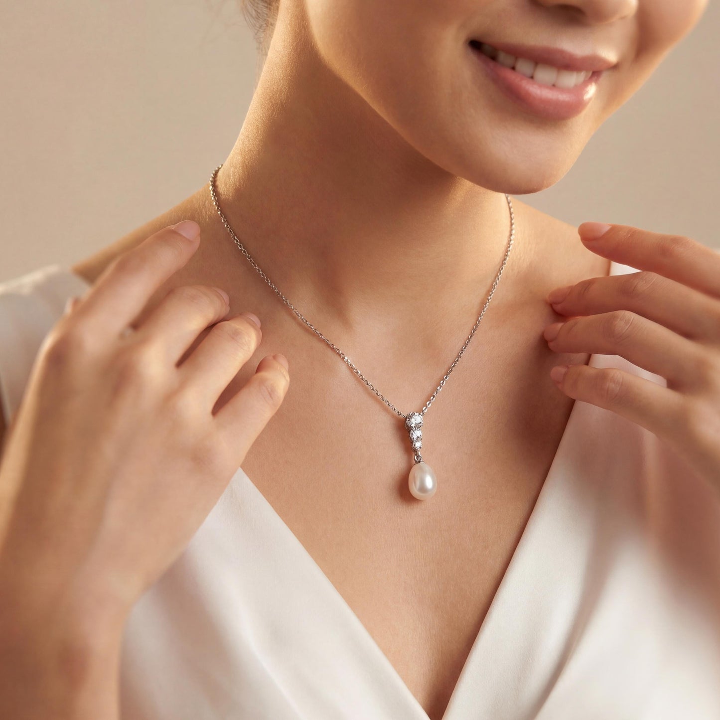 Woman wearing a pearl necklace with a soft beige background