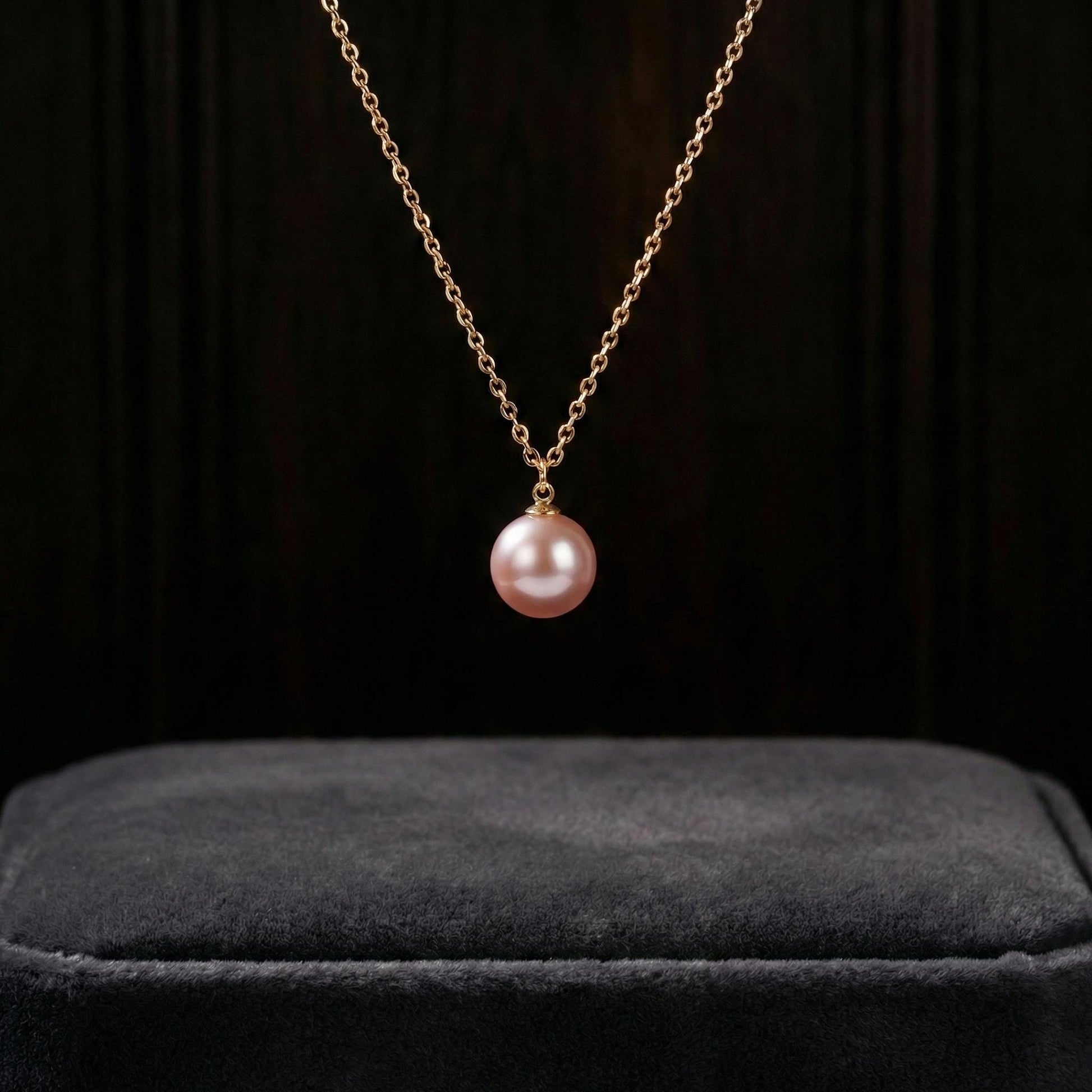 Pink pearl necklace on a black background