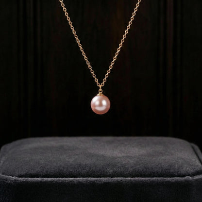 Pink pearl necklace on a black background