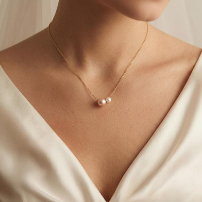 Pearl necklace on a person wearing a white dress