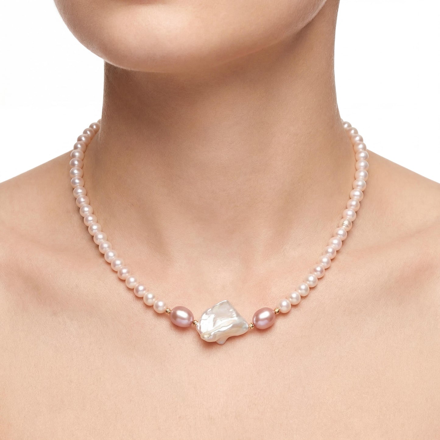 Pearl necklace with a large central pearl on a model against a white background
